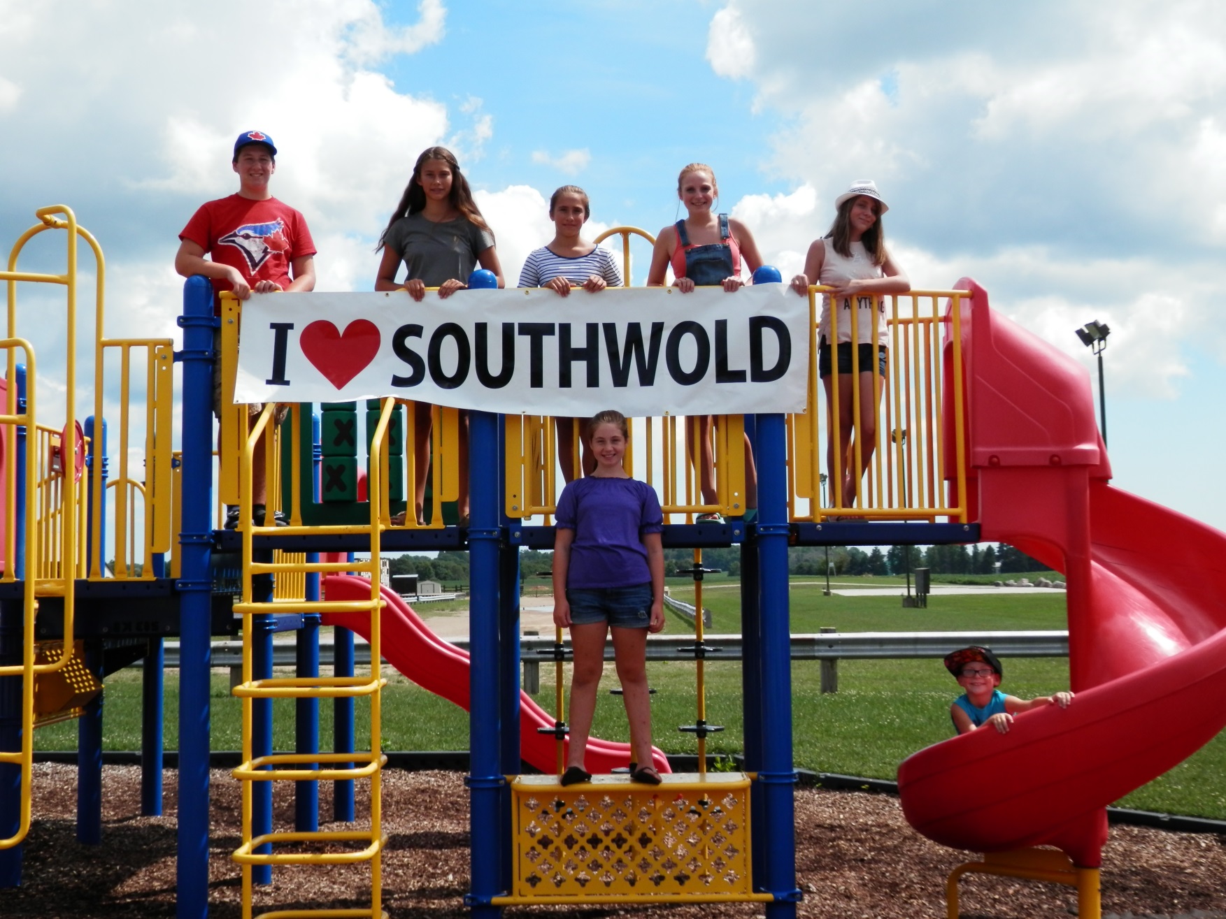 Children on playground with I Love Southwold Sign 
