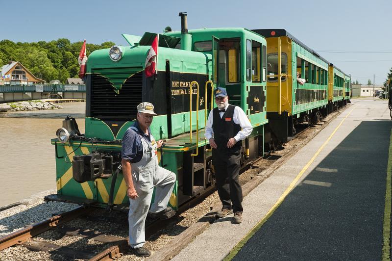 Two men standing beside the train 