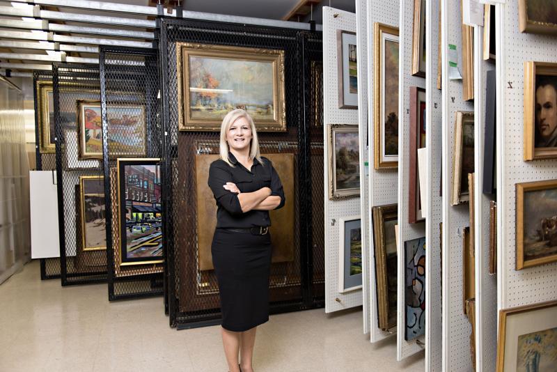 A woman standing in front of artwork 