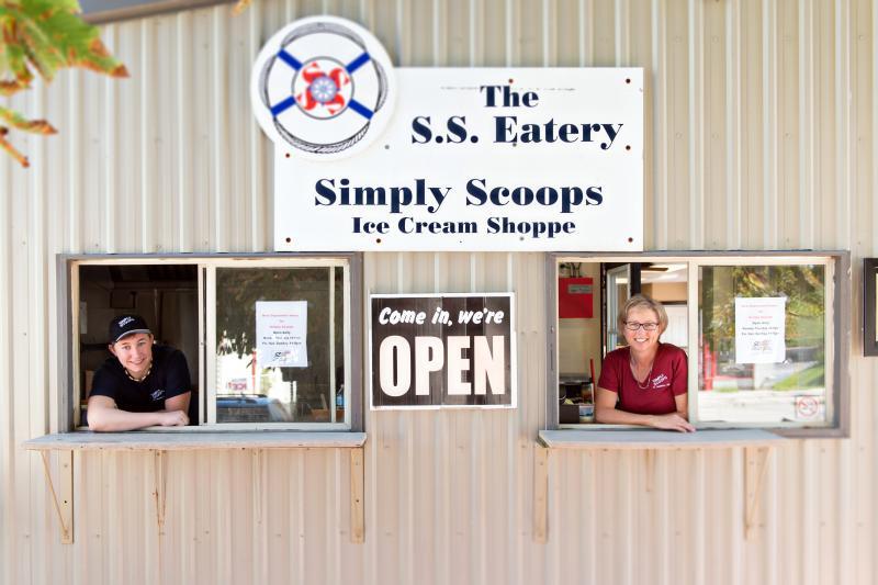 Employees looking out the window of Simply Scoops 
