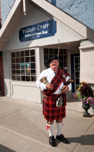 The Town Crier in front of the Village Crier Gallery